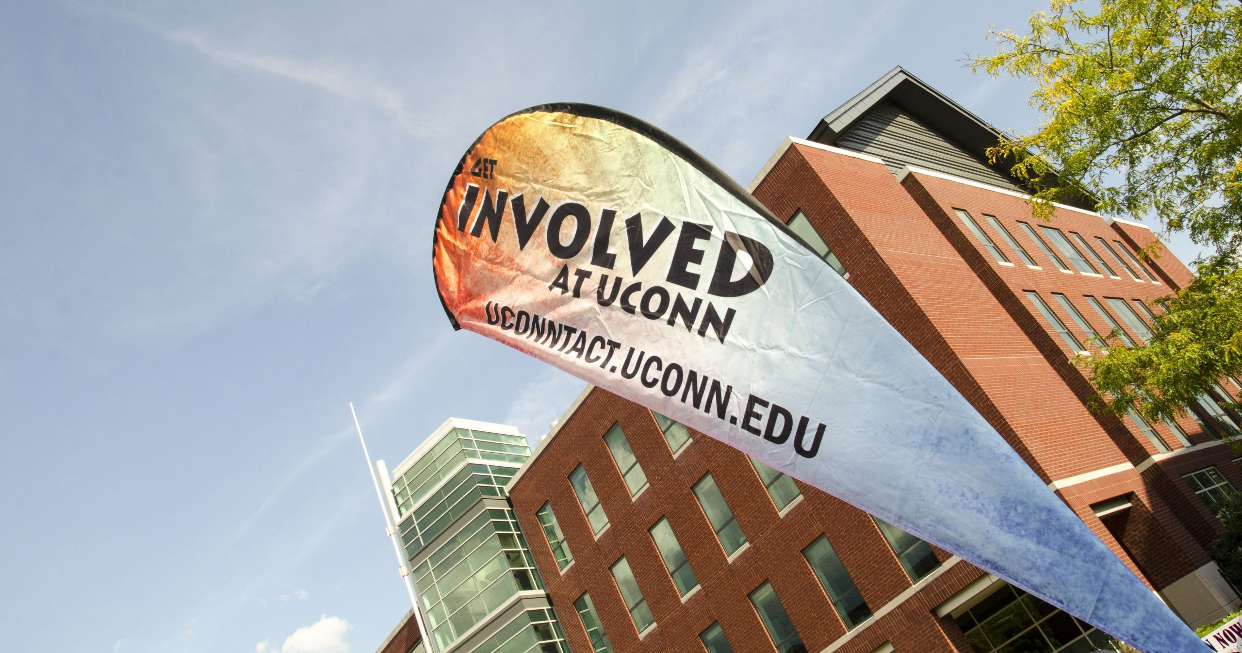 promotional flag outside of university building encouraging students to get involved at UConn