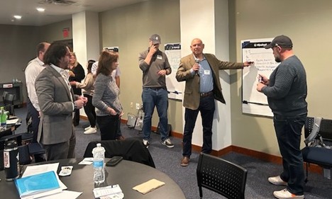Ralph Russo, ECE Economics instructor at Guilford High School, explains the Vertical Wall activity at the ECE workshop on October 22, 2025, at the Stamford campus