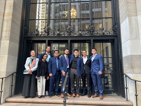 UConn Stamford Fed Challenge Team outside of the New York Fed after the Orientation, September 2025. From left to right: Dr. Smirnova (faculty adviser), Alexys Williams, Dmitrii Tuzov (graduate student adviser), Angel Bravo, Anthony Brunetto, Kothan Nieves-Orama, Jagger Ferrajina, Constantine Lampronikos.