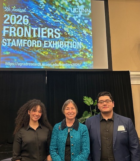 Isabella Thomas (’27), Dr. Smirnova, Economics faculty, Angel Bravo (’26) at the Frontiers in Undergraduate Research Exhibition in Stamford on April 21, 2026